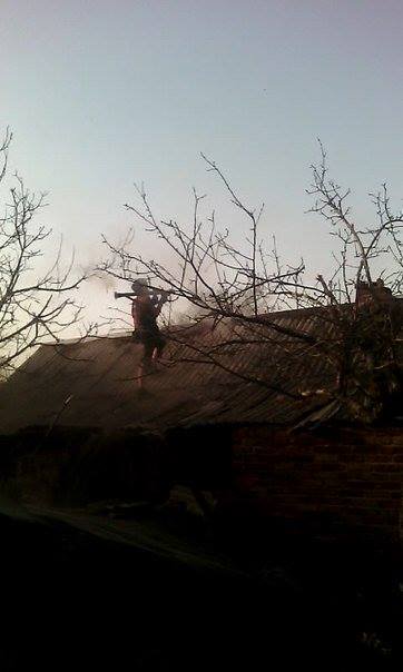 Russian militants firing from the roofs of private houses