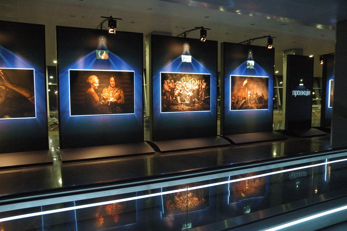 Reminders in Ukraine's Boryspil airport about Russian proxy aggression: the monitor from destroyed Donetsk airport  and  the photo exhibit.  