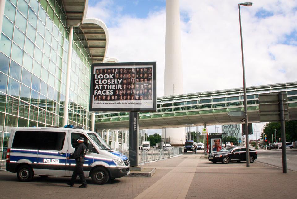 Billboard Look Closely At Their Faces at G20 venue in Hamburg was removed this morning