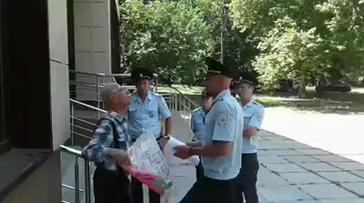 Old man was detained in Occupied Crimea for banner Putin, our children are not terrorists!. 